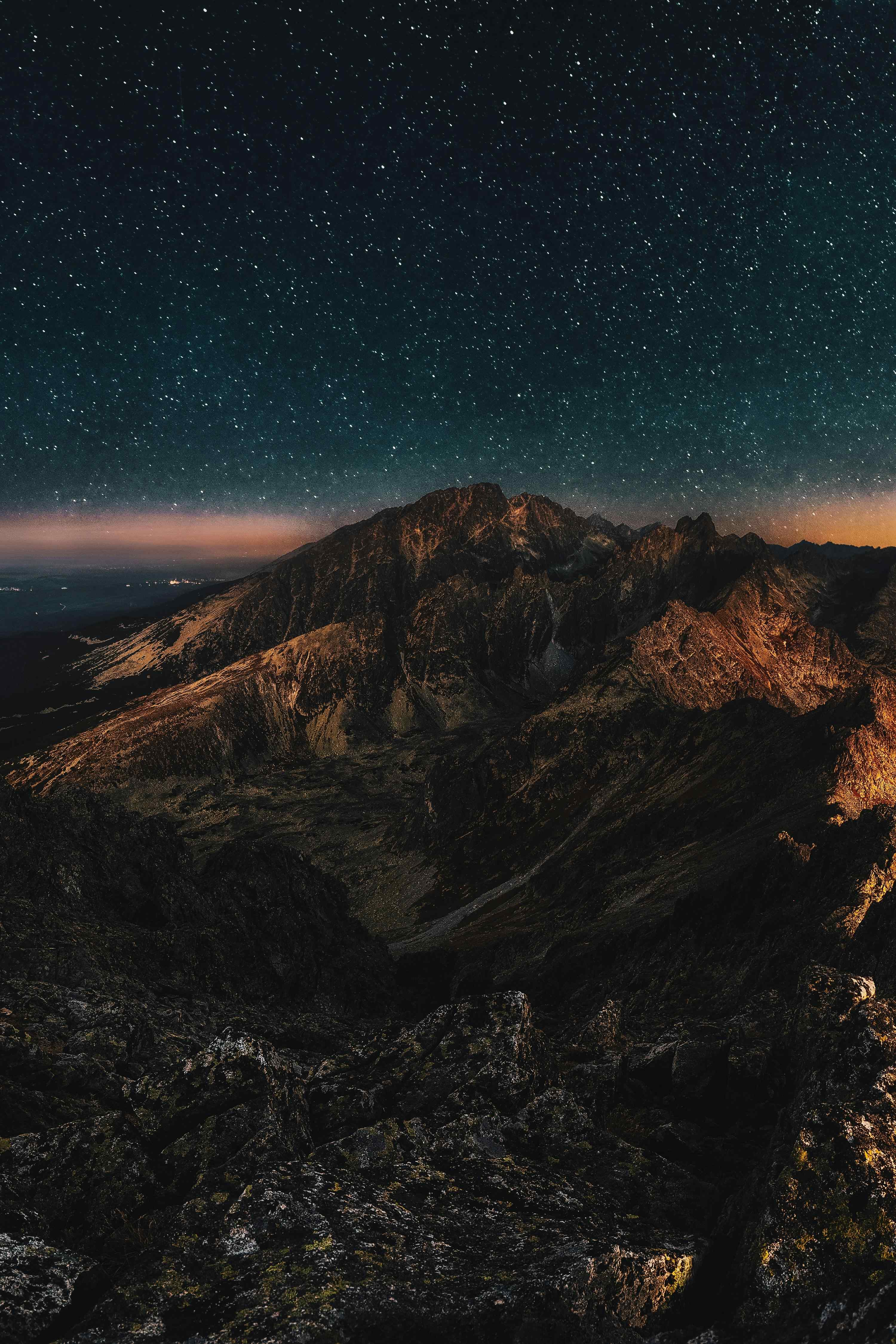 Mountain at night under a starry sky